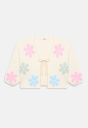 Kremfarvet cropped cardigan med bindebånd foran, med store blomster i pink, blå og grøn på for- og ærmer.