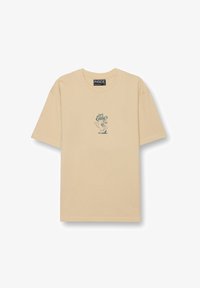 Camiseta beige de manga corta con un pequeño personaje de perrito caliente en caricatura y el texto "Uncle Eddy's" en el pecho.