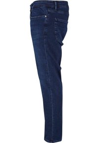 Sötétkék farmer skinny-fit nadrág. Közepes derékkal, öt zsebbel rendelkezik, és finom varrással a oldalszeleteken. Rugalmas anyag.