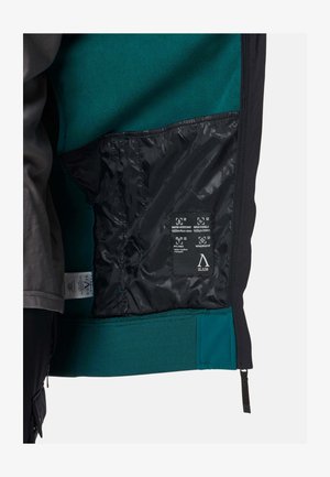 Musta takin sisäosa, jossa on tehostevärinä turkoosi fleece-vuori. Mukana vettähylkivä, hengittävä kangas ja teksturoitu helma, jossa on vetoketju.