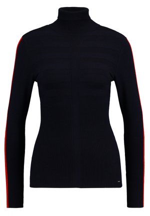 Pull en col roulé bleu marine avec texture côtelée et motif rayé horizontal sur l'avant. Présente une bande rouge vif le long de chaque manche.