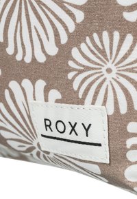 Brown and white floral pattern fabric with a textured surface. Features a white tag with the brand name "ROXY" and a black line underneath.