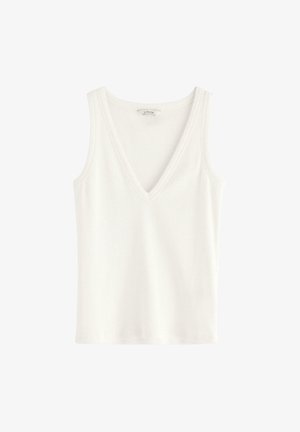 Vit bomullstopp med V-ringning, ärmlös design och ett slätt, något texturerat tyg. Rak fåll i botten.