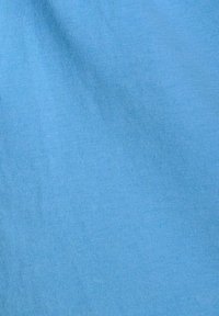 Light blue fabric with a smooth texture, featuring a ribbed pattern. No visible hardware or accents. Even coloration across the surface.