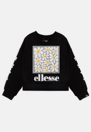 Sweat-shirt court noir avec un imprimé de marguerite blanche dans un carré avec des centres jaunes, et le logo "ellesse" en blanc sur le devant.