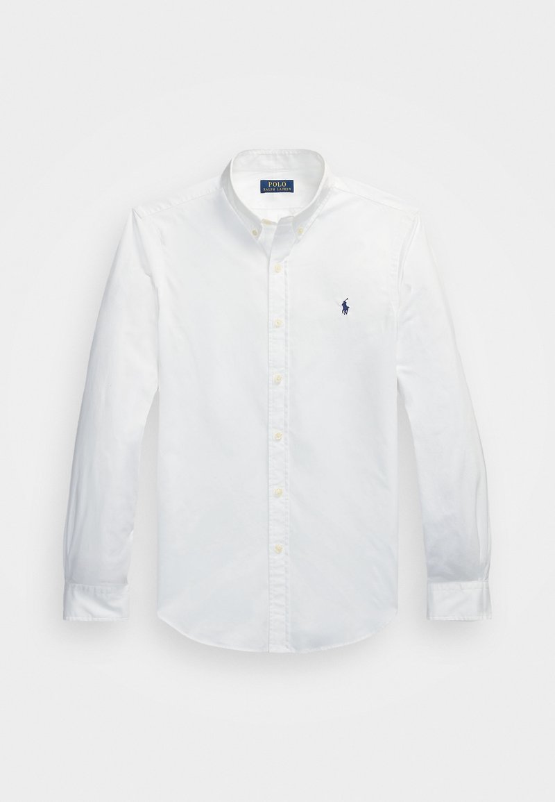 White long-sleeve button-up shirt made of cotton, featuring a pointed collar and a small blue logo on the chest. Yellow buttons detail the front.