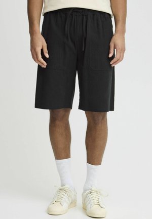 Shorts noirs en coton avec une taille réglable à cordon, deux poches avant et une coupe décontractée, arrivant juste au-dessus des genoux.