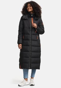 Long black puffer coat with a high collar, featuring orange zipper accents and side pockets, made from quilted, padded material.