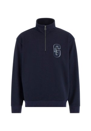 Sweatshirt bleu marine à zip quart en tissu texturé, avec un logo 'G' brodé en évidence sur la poitrine et des poignets côtelés.