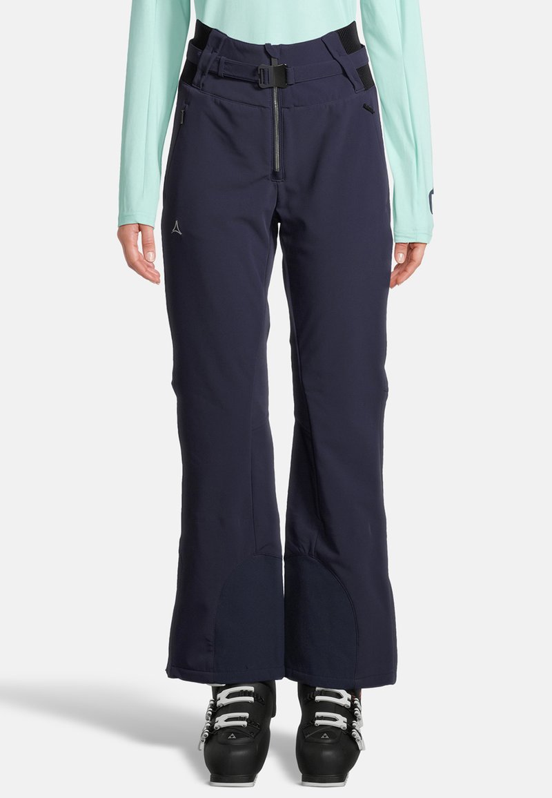 Marina skidbyxor med rak design, justerbart midjeband, fickor med dragkedja och förstärkta knäpaneler. Tillverkade av väderbeständigt material.