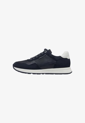 Navy blue athletic shoe with mesh and suede panels, textured surface, white accents on the heel, and a thick rubber sole with a tread pattern.