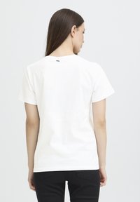 White short-sleeve T-shirt with a round neckline, made from cotton. Features a black label at the back and a smooth texture.