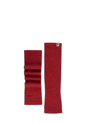 Red wool arm warmers feature a smooth texture, with one long straight design and one with a gathered section. A small logo is visible.