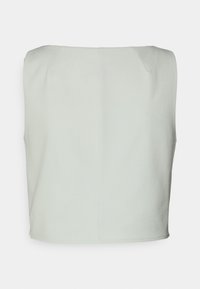 Ljust grön, ärmlös topp med en ren, rak design och subtila sömmar samt rundad fåll. Mjuk tyg med en jämn textur.