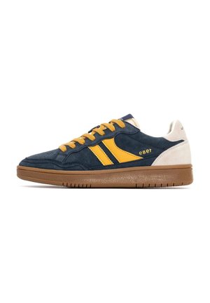 Baskets en suede bleues avec des accents et des lacets jaunes, dotées d'une semelle en caoutchouc et d'un panneau de talon blanc. Logo visible sur le côté.