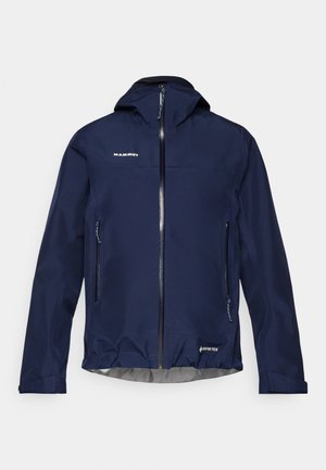 Granatowa, wodoodporna kurtka wykonana z materiału Gore-Tex, z kapturem, zamkiem błyskawicznym z przodu oraz bocznymi kieszeniami, z elastycznym dołem i mankietami.