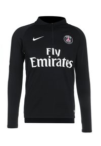 Schwarzes langärmliges Sportoberteil mit einem Halb-Reißverschluss-Kragen. Mit einem weißen "Fly Emirates"-Logo und einem runden Vereinswappen auf der linken Brust.