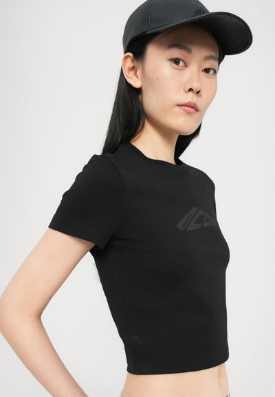 Black cropped t-shirt with short sleeves features a subtle logo on the front. Soft, fitted, with a smooth texture and a round neckline.