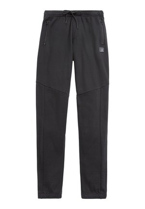 Melnas sporta bikses, izgatavotas no mīksta, elastīga auduma. Izceļas ar elastīgu jostasvietu ar auklu, sānu kabatām un sašaurinātiem piedurkņu galiem.