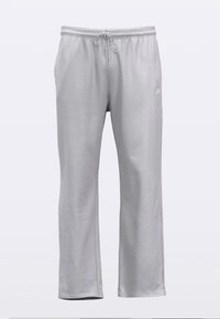 Szare spodnie sportowe o luźnym kroju, z troczkiem w talii, miękką teksturą i małym białym logo po lewej stronie.