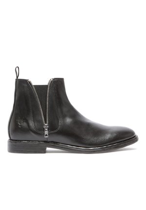 Bottine en cuir noir avec fermeture zippée sur le côté, texture lisse, bout arrondi et petit talon empilé, dotée d'une boucle pour un enfilage facile.