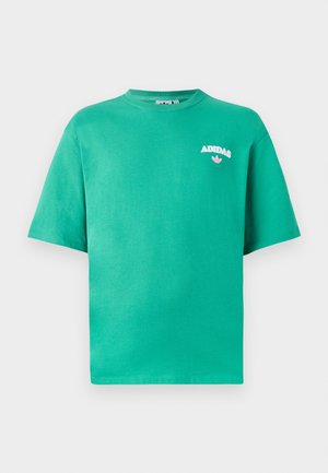 Green cotton t-shirt with a crew neckline, short sleeves, and embroidered "ADIDAS" logo on the chest, featuring a floral accent below the text.