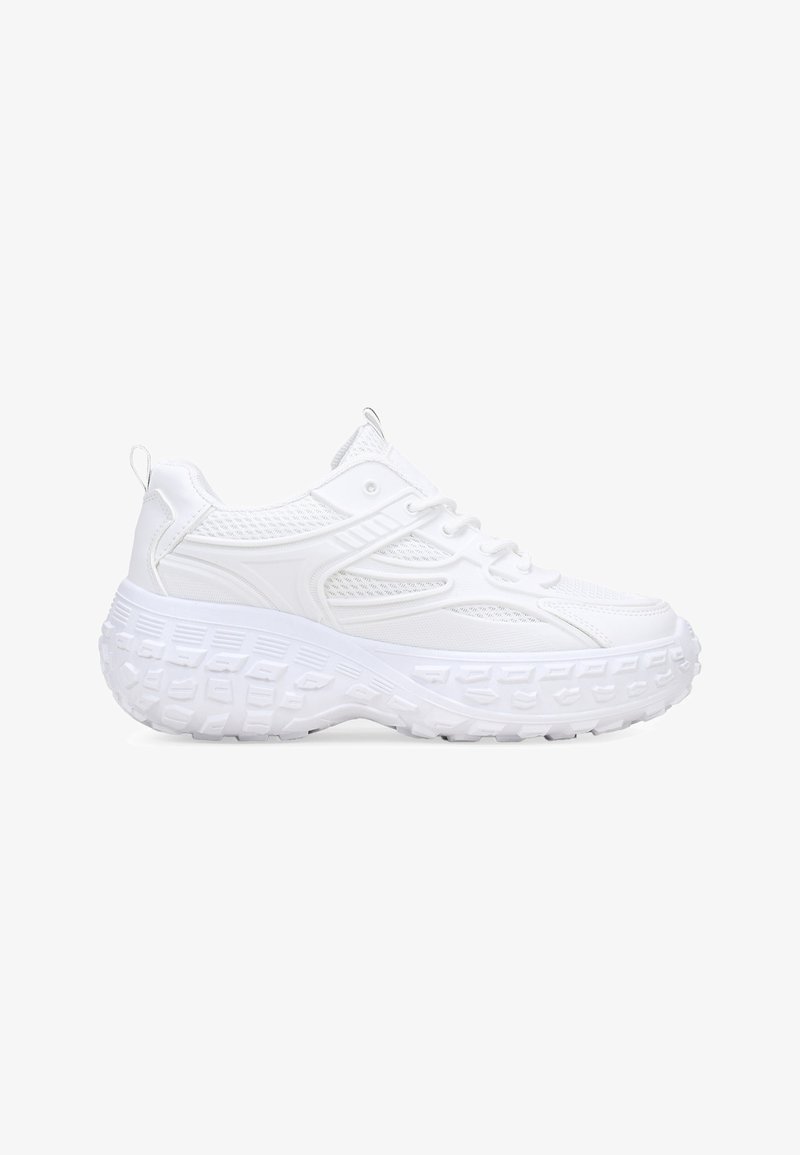 White athletic sneakers featuring a textured, breathable mesh upper, thick rubber sole with a prominent tread pattern, and lace closure.