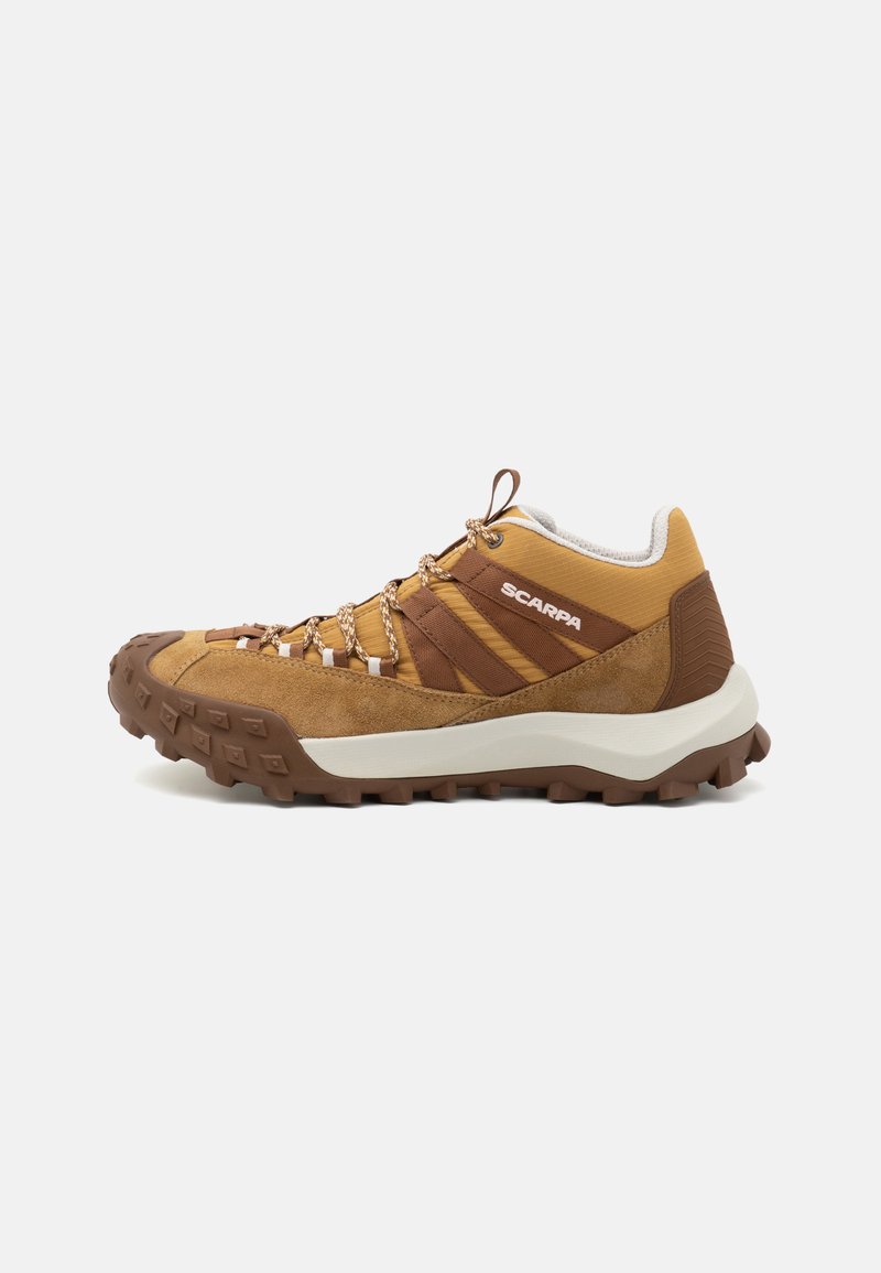 Scarpa da trekking marrone con tomaia in suede e tessuto, suola in gomma testurizzata e lacci decorati. Presenta un colletto imbottito e un logo sul lato.