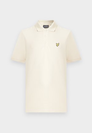 Cream-colored polo shirt made of soft fabric, featuring a two-button placket and a yellow embroidered logo on the left chest.