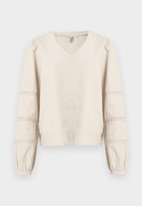 Vaaleanbeige pusero, jossa V-aukko, pitkät pöyhkeät hihat ja pitsikoristelu hihojen resoreissa. Valmistettu pehmeästä, teksturoidusta kankaasta.