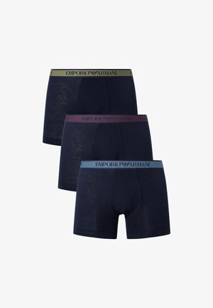 Three pairs of navy blue boxer shorts. Each features a different waistband color: green, burgundy, and light blue, with "Emporio Armani" logo.