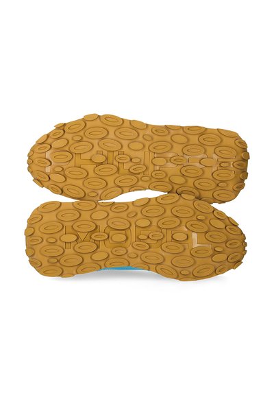 Rubber shoe sole with a textured golden brown surface. Features oval and circular patterns for grip and durability.