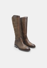 Knee-high brown leather boots with a glossy finish, featuring a side zipper and a low block heel, shaped to follow the leg contour.