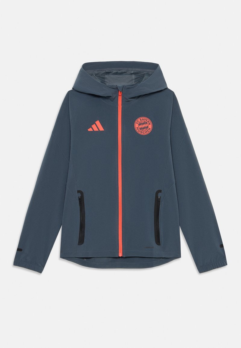 Giacca leggera blu navy con cappuccio; presenta una zip frontale arancione, tasche con zip nere e un logo del Bayern Monaco sul petto.