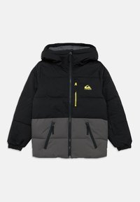 Fekete és szürke kapucnis téli dzseki elöl cipzárral, három cipzáras zsebbel, rugalmas mandzsettával, valamint sárga logóval és cipzárhúzóval a mellzsebén.