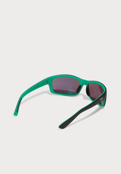 Sport sunglasses with a green and black frame, featuring wraparound design and dark tinted lenses. Textured accents on the arms.
