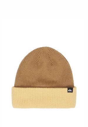 Knit beanie with light brown top and beige folded cuff, featuring a small black tag with a white wave logo on the cuff's edge.