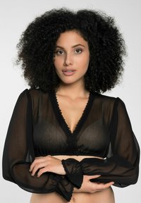 Schwarze transparente Bluse mit langen Puffärmeln, V-Ausschnitt und Spitzenverzierungen entlang der Kanten. Verfügt über eine weiche, durchscheinende Textur.