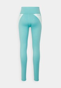 Leggings turchesi con vita alta, dotati di pannelli accentuati bianchi e un tessuto morbido e elastico. Inclusi tasche laterali.