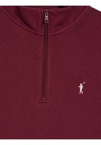 Maglione bordeaux con mezza cerniera e piccolo logo bianco del giocatore di polo ricamato sul petto.