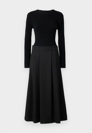 Black two-piece outfit featuring a ribbed long-sleeve top and a flowing A-line skirt, both in solid black with a smooth texture.