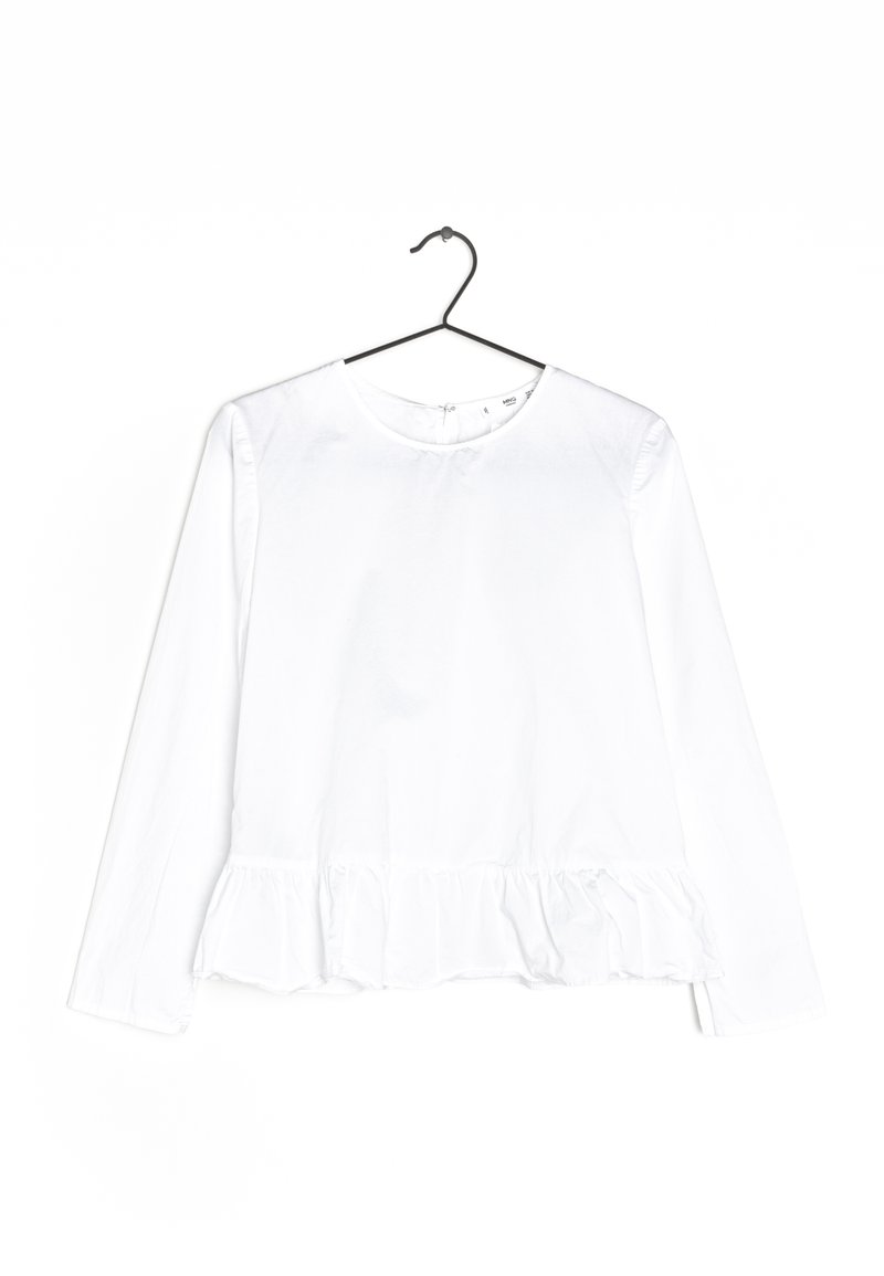 Haut blanc à manches longues avec un col rond et un volant évasé à l'ourlet. Fabriqué en tissu léger. Design épuré et simple.