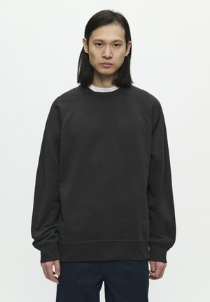 Dark gray sweatshirt with raglan sleeves, ribbed cuffs, and hem. Made of soft fabric, featuring a small logo on the chest.