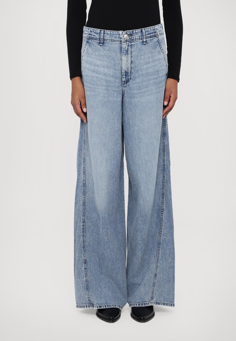 Wide-leg blue denim jeans with a high waist, featuring front pockets and contrasting stitching along the seams. Smooth texture.