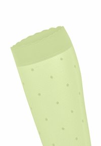 Hellgrüne gepunktete Strumpfhosen mit einem strukturierten Netzdesign, ausgestattet mit einem gewellten oberen Rand und gleichmäßig verteilten Punktmustern.