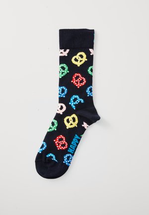 Navy sock with colorful polka-dot pretzel patterns in red, yellow, green, blue, and pink, with the word "HAPPY" in blue near the toe.