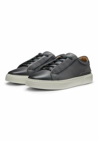 Black leather sneakers with a smooth finish, featuring tonal laces, reinforced stitching, and a white rubber sole for contrast.
