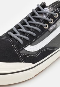 Crne ante skate tenisice sivi su vezice, bijela bočna pruga i bijelo šivanje. Tekstura gumeni potplat s suptilnim uzorkom.