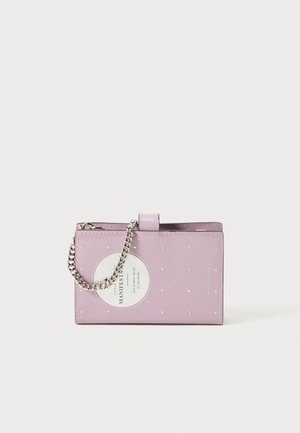 Purple faux leather wallet with silver chain strap, featuring a circular tag and small silver dot patterns on the exterior.