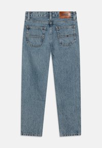 Heledad denim teksad sinise tooni otse lõikega, kaks tagumine taskut ja pruun nahast brändi silt vööl.